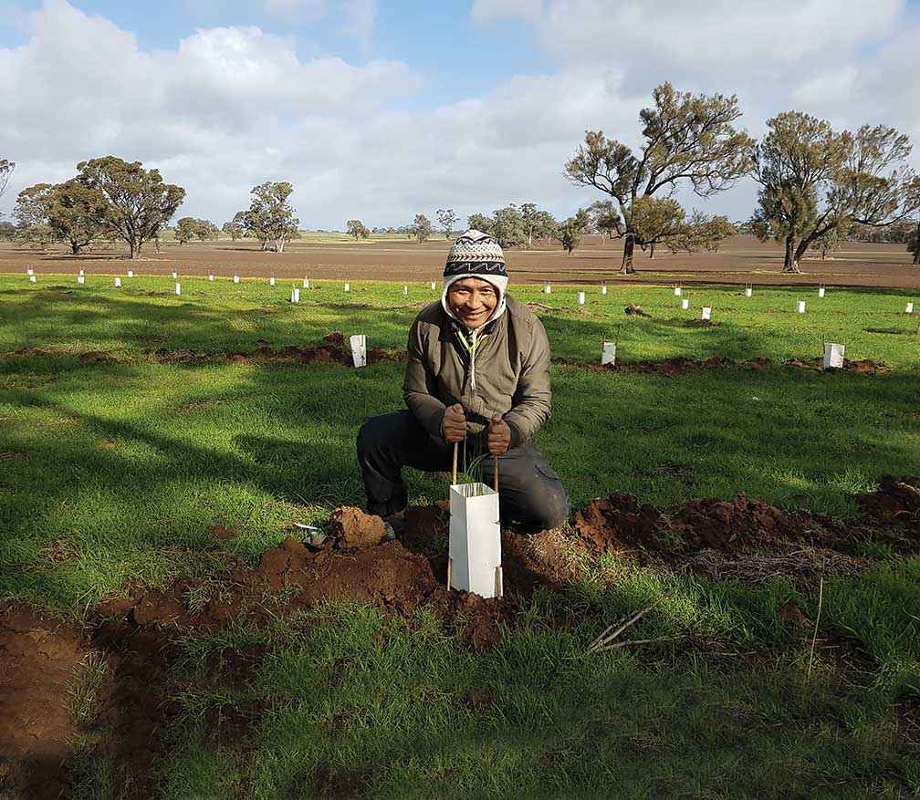 Kaw Doh Htoo from Nhill getting his hands dirty at a Project Hindmarsh planting weekend at Dinyarrak in 2018.