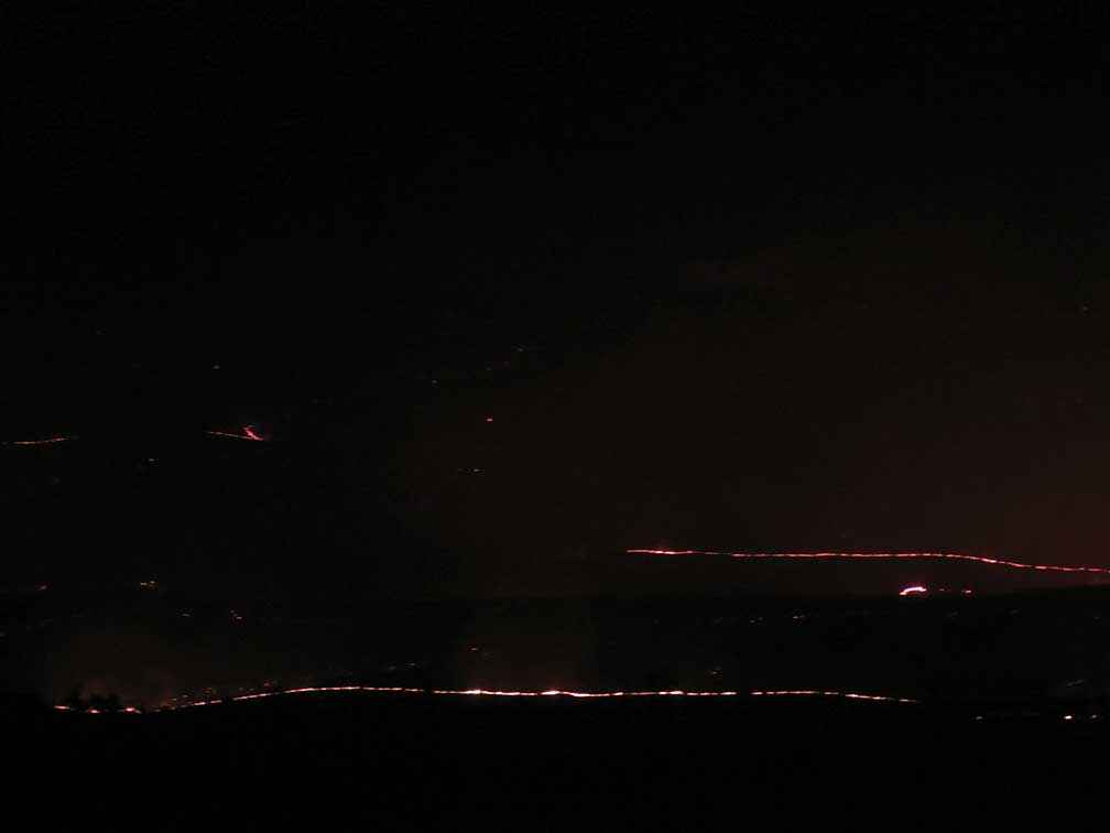 The glowing rim of the uncontrolled fire seen from a hilltop at John Robinson and Farideh Lashkary’s property at Bylands on Sunday 9 February 2014.