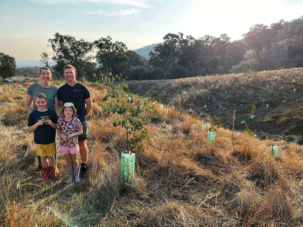 Travis Edmondson and his family at the revegetated erosion gully on their property at Barnawartha North.<br />
