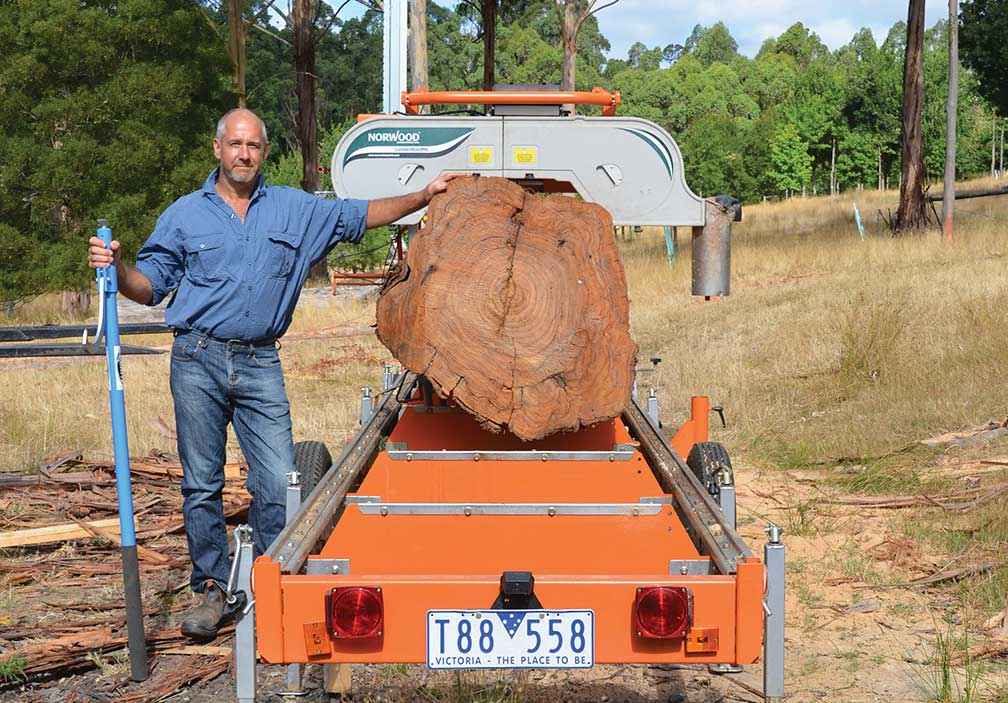 Rowan Reid with a 25-year-old eucalypt log on the bandsaw.