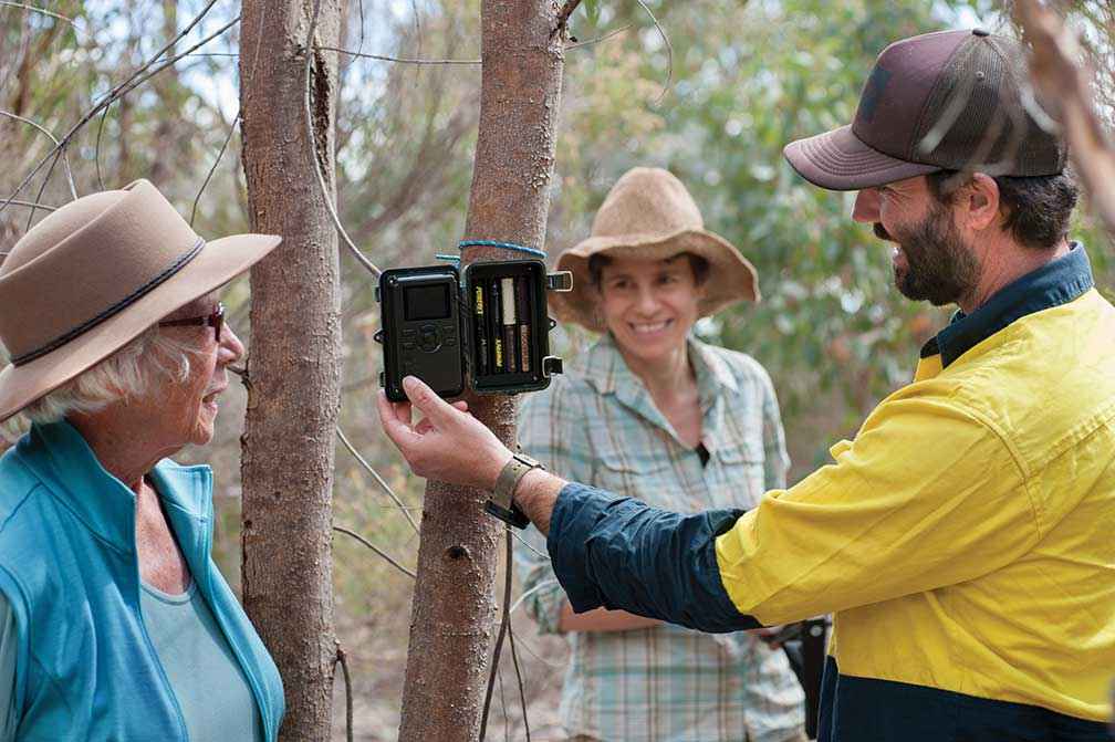 UCLN’s Threatened Species Officer Brad Blake shows Campaspe Valley Landcare Group President Jan Elder and volunteer Jessica Rosien how to set up a remote sensing camera.