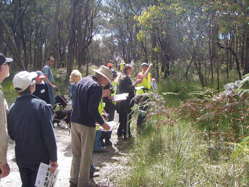 Caroline Gully (at right), from the West Gippsland Seedbank, helps to identify indigenous plants on a nature walk at Sweetwater Creek.