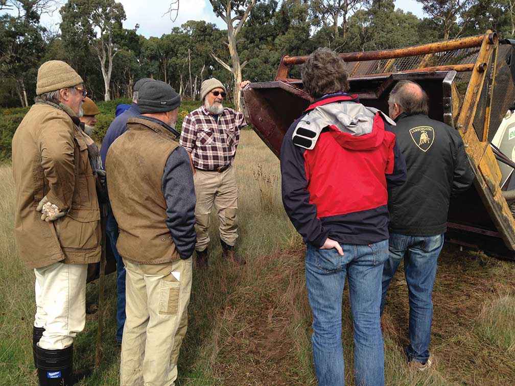 Landholders inspect a gorse mowing attachment at a Tylden Landcare Group field day.
