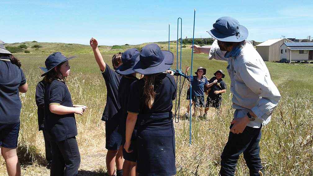 Volunteer Richard Chamberlain teaching students from Port Fairy Consolidated School how to radio-track snipe. 
